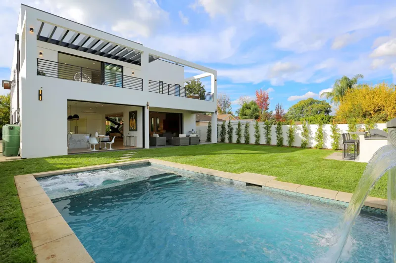Finished two-story modern home with a pool and lawn out back