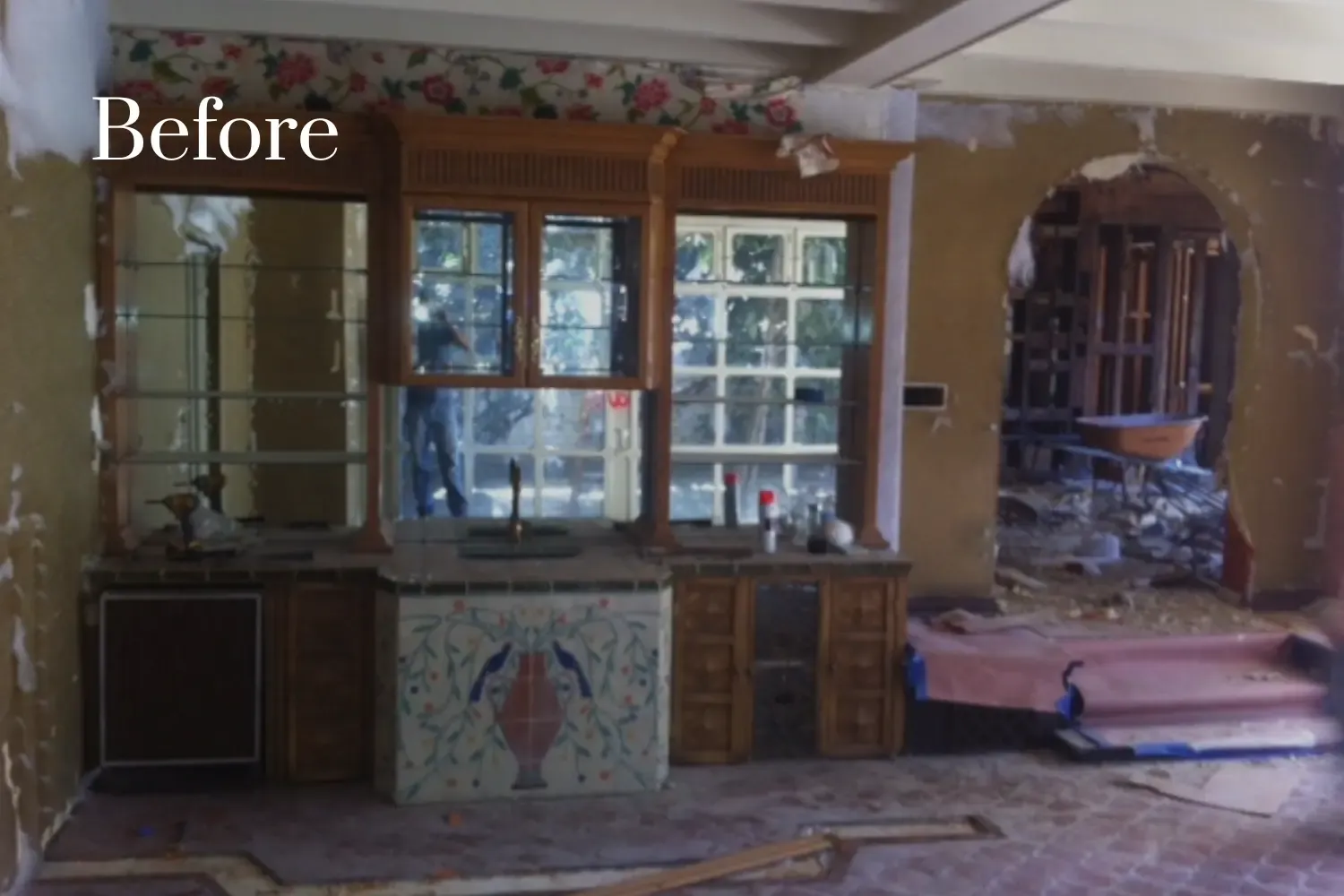Lounge and wet bar before remodel — cluttered, dark, and uninviting