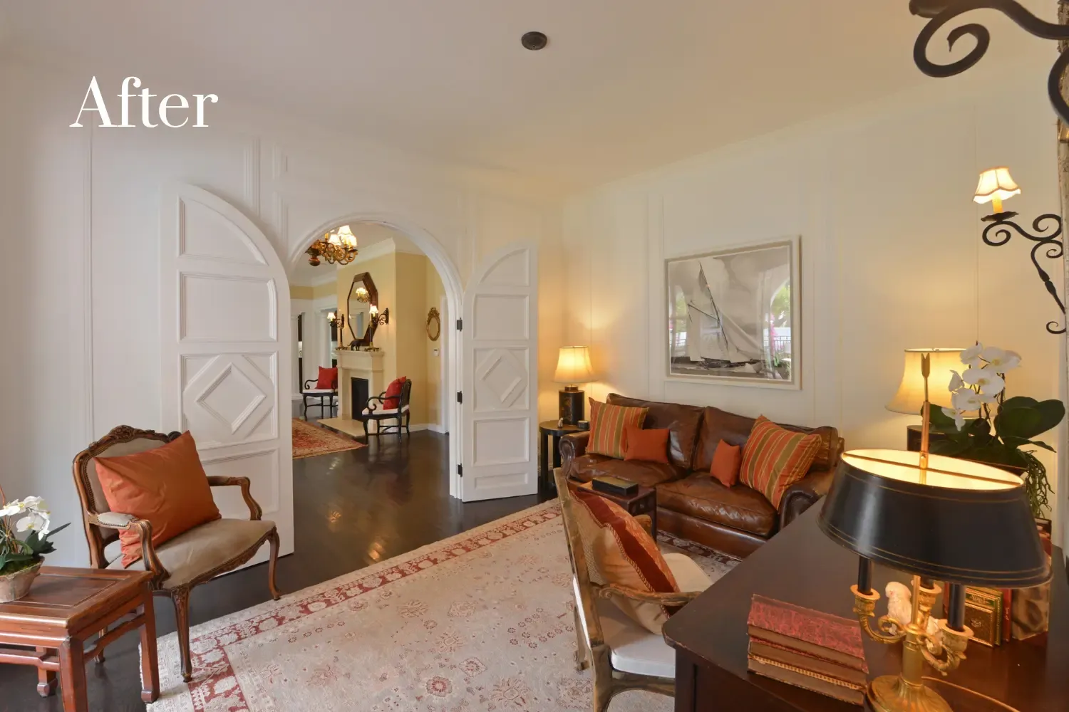 Entryway after remodel — custom double doors, wall paneling, and hardwood flooring