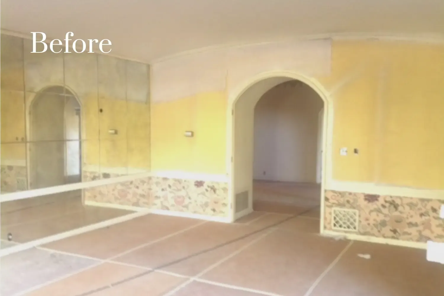 Entryway before remodel — mismatched wallpaper and outdated mirrored walls